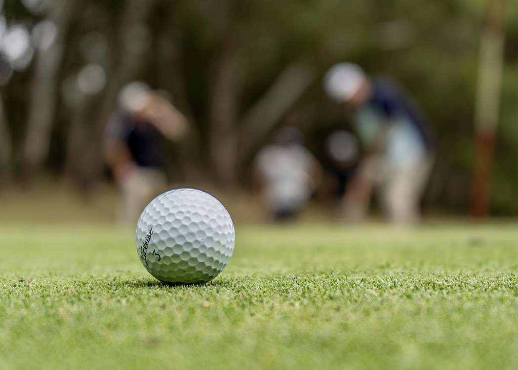 Golf ball with blurred people behind